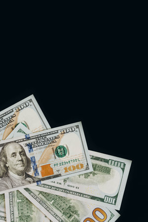 Many dollar banknotes on black background isolated, flat lay.の写真素材