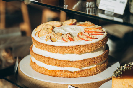 Sponge peach cake with cream and pieces of fresh peach.の写真素材