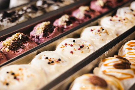 Various buns are in trays behind the glass of the showcase.