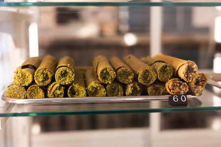Wafer rolls with condensed milk, decorated with pistachio in a coffee shop.