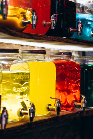 Juice and cocktails in a glass jar. Cocktails in containers with a tap.の写真素材