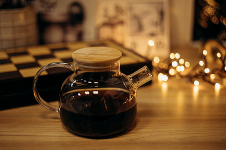Puer tea teapot with chessboard and holiday bokeh lights.の写真素材