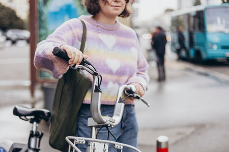 A young woman commuting to work on a bike in big city in the morning.の写真素材