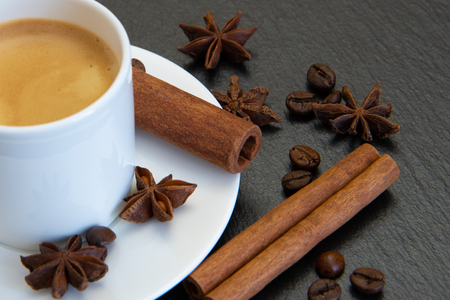 Coffee set. Espresso drink in white cup with cinnamon quills and star aniseの写真素材