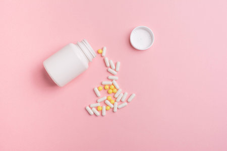 Creative concept Illness:  vitamins in a jar on pink backgroundの写真素材