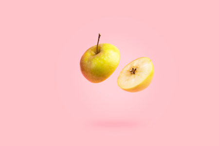Apple slices on pastel pink background. Concept minimal fashion food の写真素材