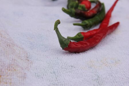 hot pepper red and green on a white background. Hot seasoning.の写真素材