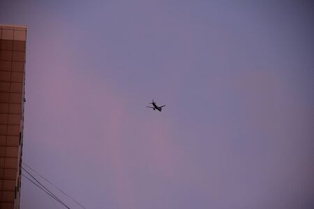 plane flies in the morning sky at low altitude.