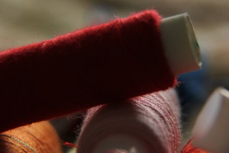 macro-shooting coils with multi-colored threads. close-up of sewing threads.