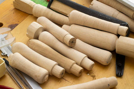 wooden blanks to replace the handles of tools .a lot of details in on the table in the carpentry...