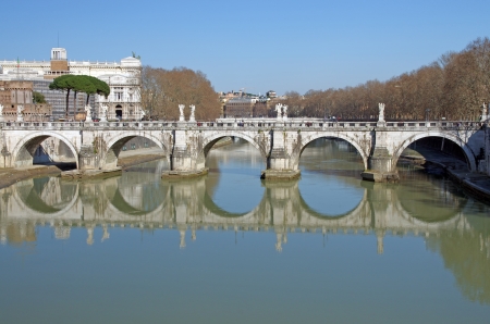 Saint Angelo bridge reflecting in Tiber river, Romeの写真素材