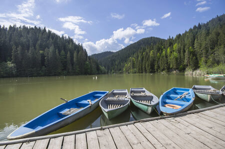 Boat docks on a beautiful lake in forest  Red Lake in Romania の写真素材