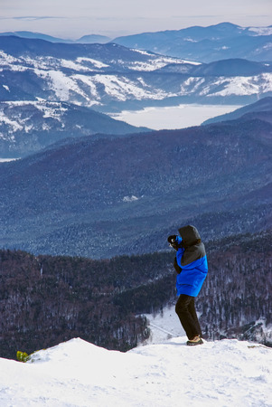 Tourist taking photos on mountain.の写真素材