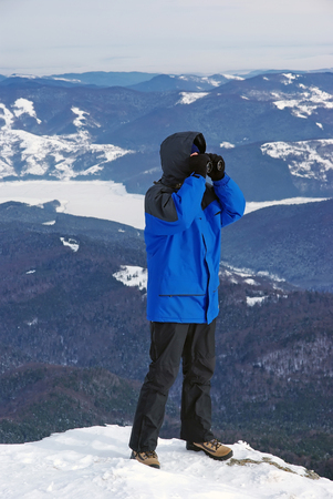 Man searching with binocular on mountain.のeditorial素材