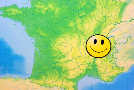 Yellow happy face on France map, close up image.の写真素材