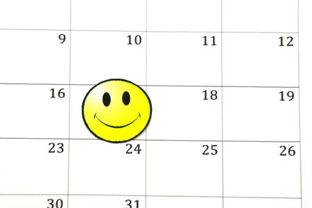 Smile face on a calendar, close up image.の写真素材