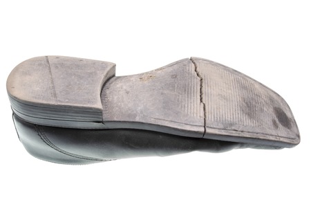 Damaged sole of a black shoe isolatedの写真素材