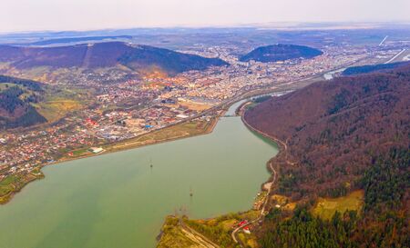 Aerial view of Piatra Neamt, lake and nearby hillsの写真素材