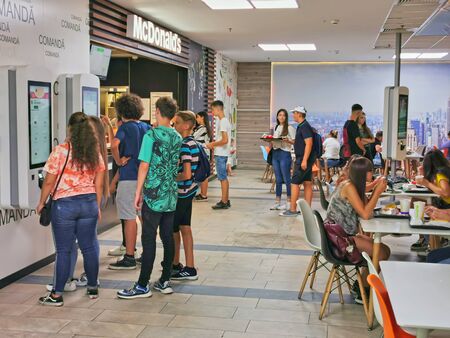 BACAU, ROMANIA - AUGUST 20, 2019: People at self service desks or waiting for food at McDonalds