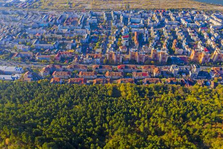 Above view of residential buildings near autumn forest, Piatra Neamt cityの写真素材