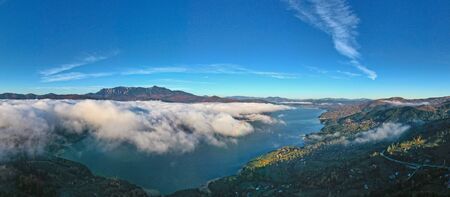 Mist cloud panorama, aerial view of mountain lake covered by mist cloud in Romanian Carpathians,...