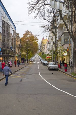 KIEV, UKRAINE - NOVEMBER 16, 2019: Small street lined with parked carsalong the street in Kievのeditorial素材