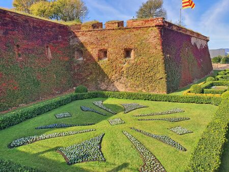 Green yard and ancient fortification, Montjuic Castle, well known landmark in Barcelona.のeditorial素材