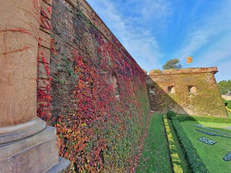 Green yard and ancient fortification, Montjuic Castle, well known landmark in Barcelona.のeditorial素材