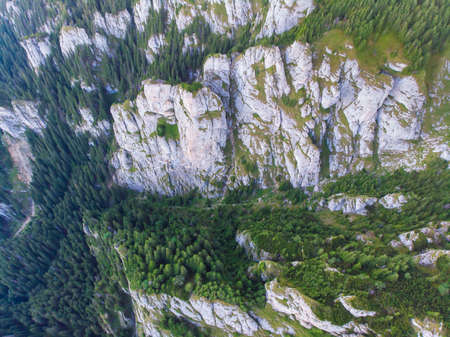 Above view of rocky mountain landscape, huge rocks and green forest in summer, Romanian Carpathiansの写真素材