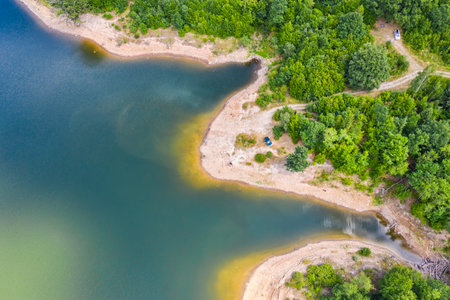 Green lake shore viewed from above in Romanian Carpathiansの写真素材