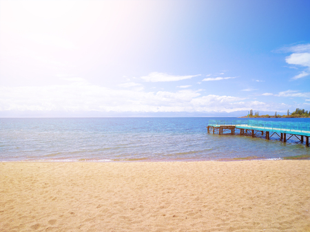 Sandy shore. calm ocean. Large pier. Perfect vacationの写真素材