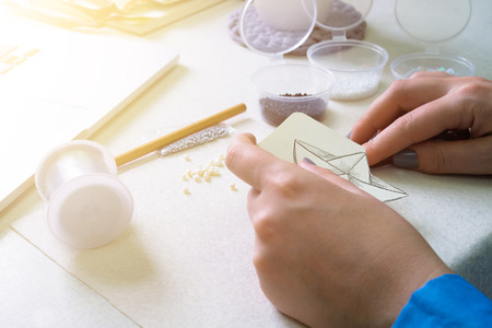 Girl is engaged in creative activity in the workshop