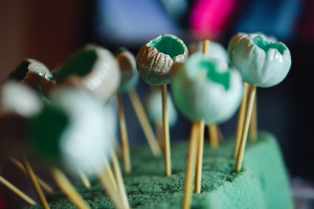 Blue buds of polymer clay on sticks drys up. Handmadeの写真素材