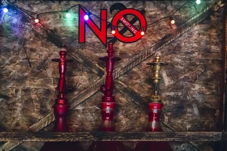 Three hookahs on the shelf under the inscription not to smokeの写真素材