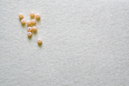 Some zircon and felt on the white table. Top view.の写真素材