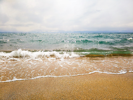 Small wave on a sunny day by the seaの写真素材