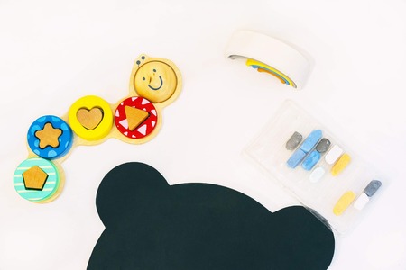 Top view of white tabletop with various drawing tools and toysの写真素材