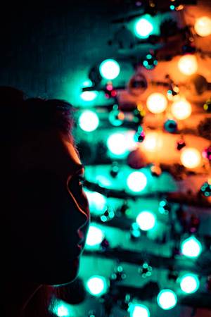 Woman on a Christmas night against a background of a bright Special Christmas tree made of twigs...