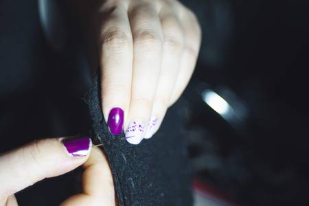 Close up woman hands of seamstress at work with tissue fabricの写真素材