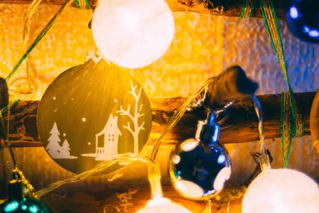 The keychain with the image of the village hangs on the tree as an ornament. Christmas night. Happy...