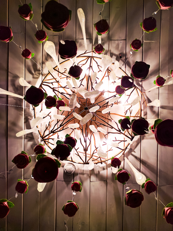 Chandelier on the ceiling.Art Steel Lanttern, Designed Iron lamp, Yellow steel structure around the Light bulb, looking from below.の写真素材