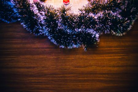 Christmas banner with a frame of spruce, on a wooden board background. The concept of winter vacations.の写真素材