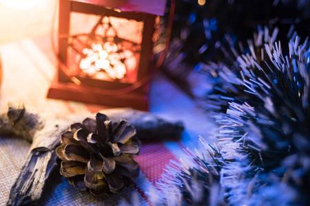 Christmas decorations. The night of the holiday. A fir-tree and a candlestick with a candle stand at...