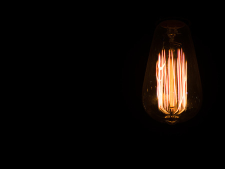 Edison's light bulb in the dark with copy space for textの写真素材