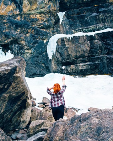 Freedom traveler woman standing. with raised arms and enjoying a beautiful nature.の写真素材