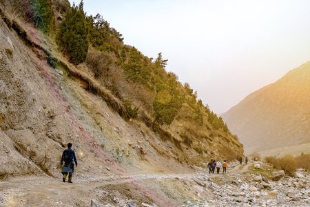 Hikers in the mountains. Group of friends or tourists walks at mountains viewpoint. Travel or tourism concept.の写真素材