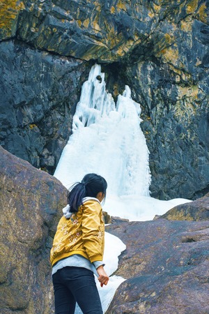 Woman travel in mountains alone. Young female hiking in mountains during autumn.の写真素材