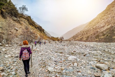 Hikers in the mountains. Group people backpackers tourists climbing struggling ascending rock mountain ridge travel tourism destination hiking.の写真素材