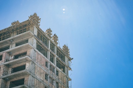 Unfinished building with blue sky in the background in a sunny day. Developing of Construction industryの写真素材
