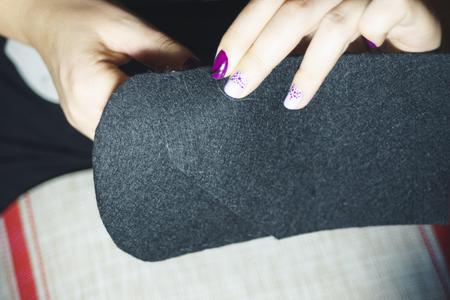 Close up women's hands sew a handbag with cloth fabric.の写真素材